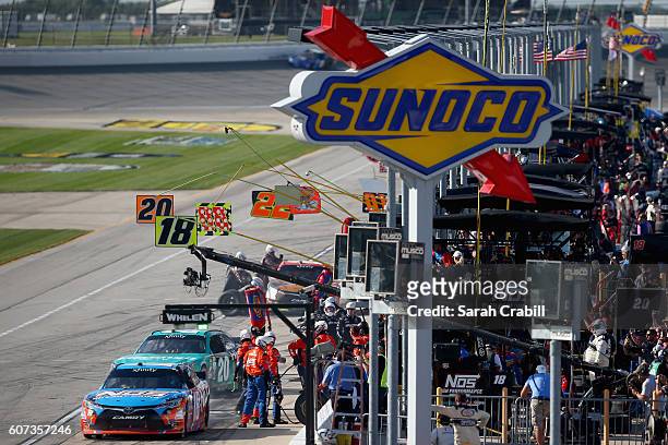 Kyle Busch, driver of the NOS Energy Drink Toyota, and Erik Jones, driver of the Hisense Toyota, pit during the NASCAR XFINITY Series Drive for...