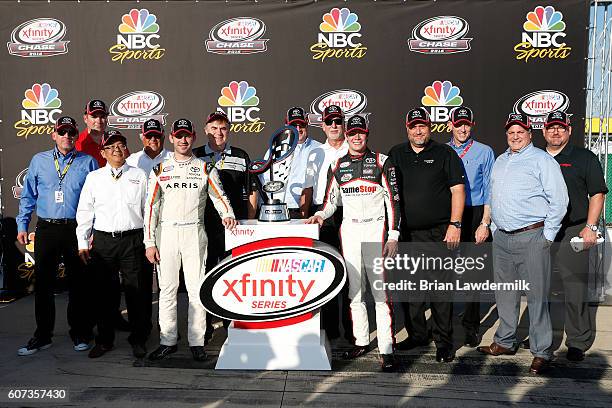 Daniel Suarez, driver of the ARRIS/TMNT Michelangelo Toyota, Erik Jones, driver of the Hisense Toyota, and Toyota executives pose with the NASCAR...