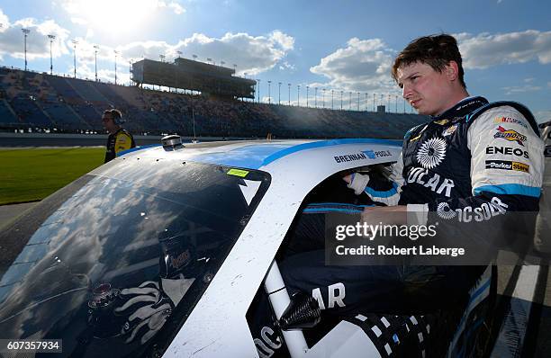 Brennan Poole, driver of the DC Solar Chevrolet, climbs from his car after the NASCAR XFINITY Series Drive for Safety 300 at Chicagoland Speedway on...