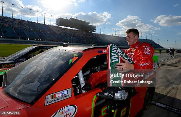 Dakoda Armstrong, driver of the Let'sTalkFood.com Toyota, climbs from his car after the NASCAR XFINITY Series Drive for Safety 300 at Chicagoland...