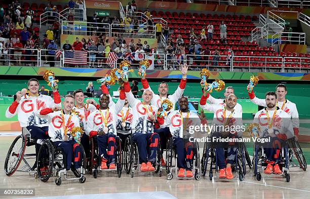 Bronze medalist Great Britain celebrate on the podium at the medal ceremony after the Men's Wheelchair Basketball competition at Olympic Arena on day...