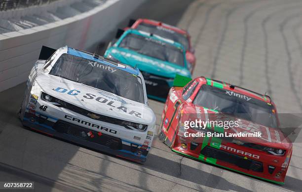 Brennan Poole, driver of the DC Solar Chevrolet, and Justin Allgaier, driver of the LetsTalkFood.com Chevrolet, race during the NASCAR XFINITY Series...