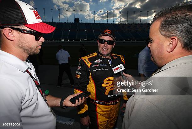 Brendan Gaughan, driver of the American Ethanol/Thorntons Chevrolet, speaks with the media after the NASCAR XFINITY Series Drive for Safety 300 at...
