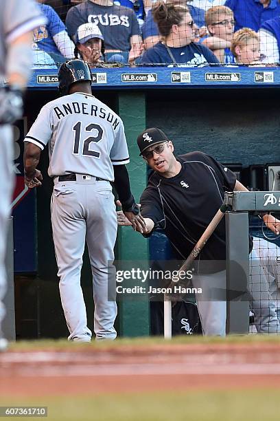 Tim Anderson of the Chicago White Sox is congratulated by manager Robin Ventura at the dugout steps after scoring the initial run of the game agains...