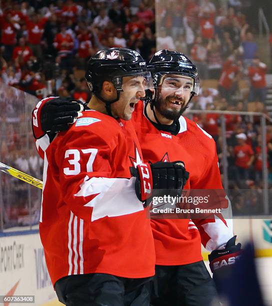 Patrice Bergeron of Team Canada celebrates his goal at 19:59 of the first period against Team Czech Republic and is joined by Drew Doughty during the...