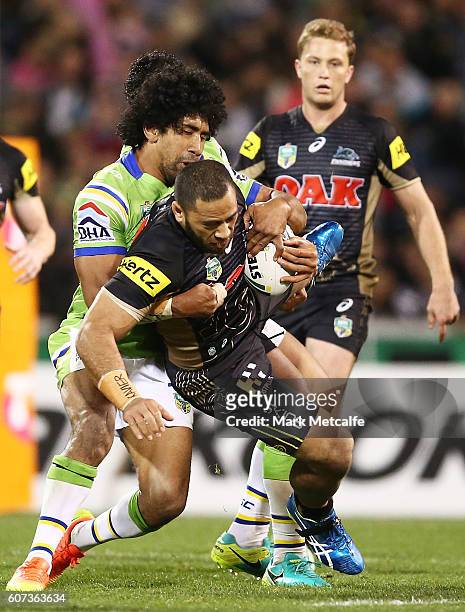 Suaia Matagi of the Panthers is tackled during the second NRL Semi Final match between the Canberra Raiders and the Penrith Panthers at GIO Stadium...