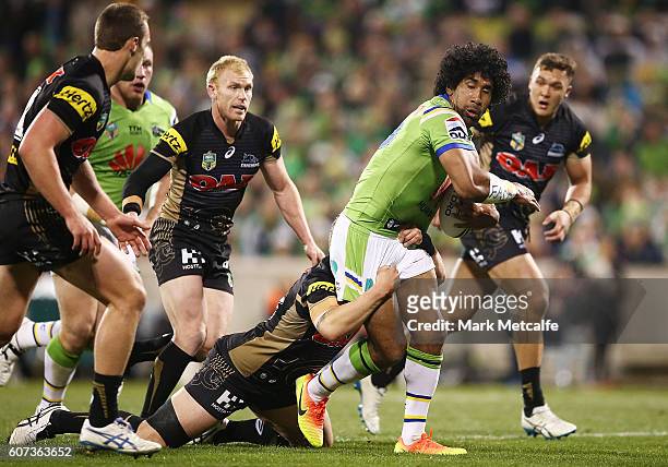 Iosia Soliola of the Raiders is tackled during the second NRL Semi Final match between the Canberra Raiders and the Penrith Panthers at GIO Stadium...