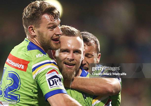 Blake Austin of the Raiders celebrates scoring a try with team mates during the second NRL Semi Final match between the Canberra Raiders and the...