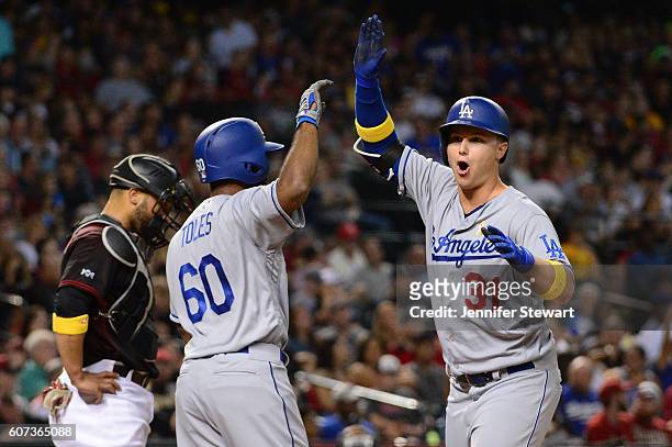 Joc Pederson of the Los Angeles Dodgers is congratulated by teammate Andrew Toles after hitting a two run home run against the Arizona Diamondbacks...