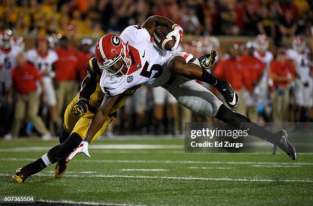 Terry Godwin of the Georgia Bulldogs is stopped short of the end zone by Aarion Penton of the Missouri Tigers in the second quarter at Memorial...