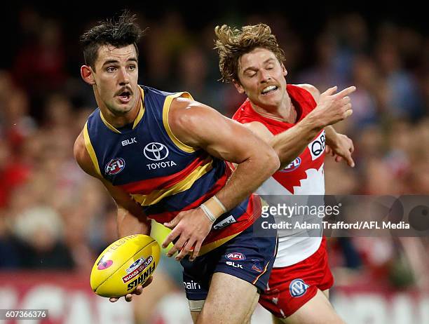 Taylor Walker of the Crows is tackled by Dane Rampe of the Swans during the 2016 AFL First Semi Final match between the Sydney Swans and the Adelaide...