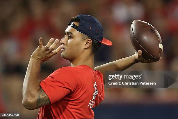 Quarterback Anu Solomon of the Arizona Wildcats throws a pass in warm ups to the college football game against the Hawaii Warriors at Arizona Stadium...