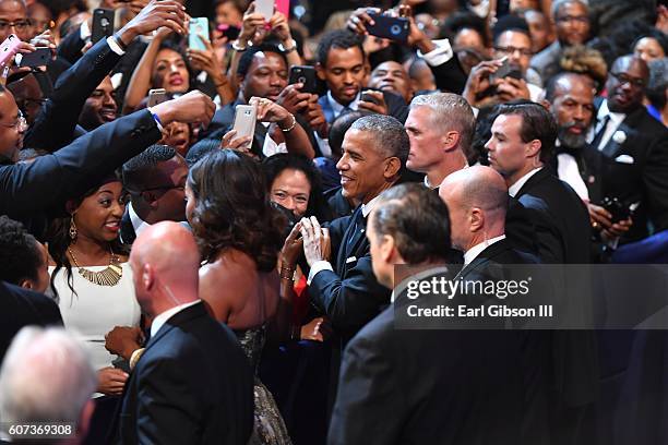 First Lady Michelle Obama and President Barack Obama greet the crowd at the Phoenix Awards Dinner at Walter E. Washington Convention Center on...