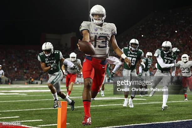 Quarterback Brandon Dawkins of the Arizona Wildcats scores on a 14 yard rushing touchdown against the Hawaii Warriors during the first quarter of the...