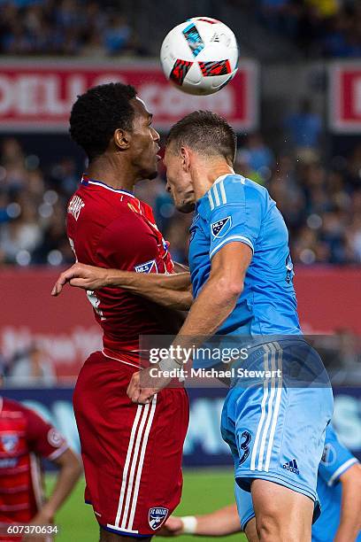 Defender Frederic Brillant of New York City FC heads the ball over defender Atiba Harris of FC Dallas during the match at Yankee Stadium on September...