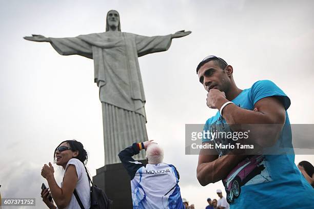 Syrian refugee swimmer Ibrahim Al Hussein stands during a tour at Christ the Redeemer statue during the Rio 2016 Paralympic Games on September 15,...