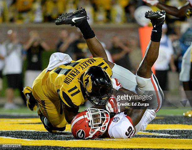Isaiah McKenzie of the Georgia Bulldogs pulls in a pass for a touchdown against Aarion Maxey-Penton of the Missouri Tigers in the fourth quarter at...