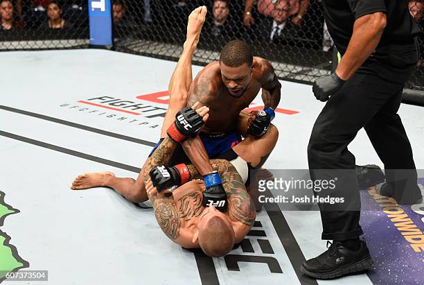 Michael Johnson punches Dustin Poirier in their lightweight bout during the UFC Fight Night event at State Farm Arena on September 17, 2016 in...