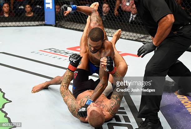 Michael Johnson punches Dustin Poirier in their lightweight bout during the UFC Fight Night event at State Farm Arena on September 17, 2016 in...