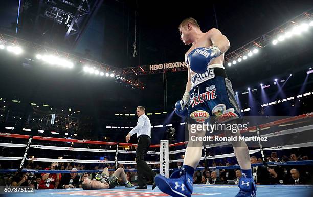 Canelo Alvarez, right, looks toward Liam Smith, left, after knocking him down during the WBO Junior Middleweight World fight at AT&T Stadium on...