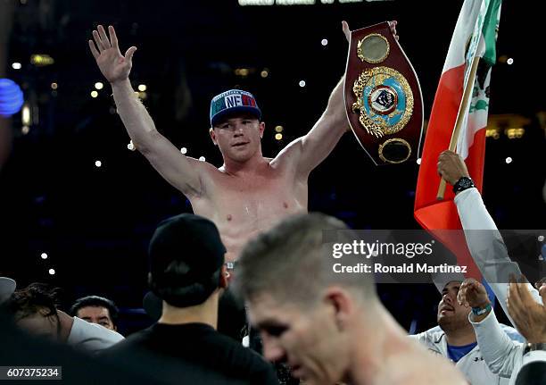 Canelo Alvarez celebrates after knocking out Liam Smith, lower, during the WBO Junior Middleweight World fight at AT&T Stadium on September 17, 2016...