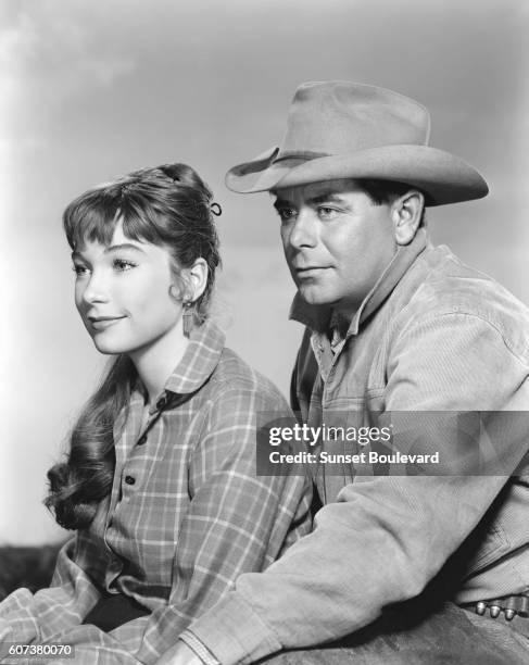 American actress Shirley MacLaine and American actor Glenn Ford on the set of The Sheepman , directed by George Marshall.