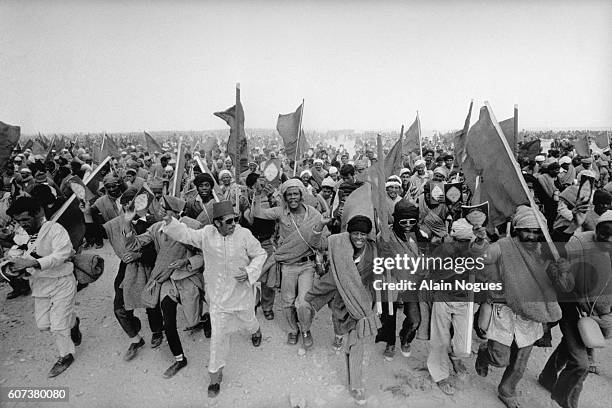 Demonstrators in the Green March step forward to West Sahara. On November 6 350,000 Moroccan volunteers peacefully occupied the Spanish Sahara. This...