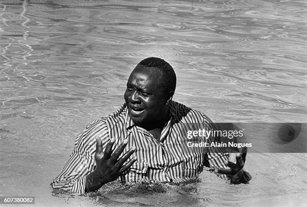 Dictator Idi Ammin Dada bathes at the Hilton Hotel's swimming pool between two OUA sessions.