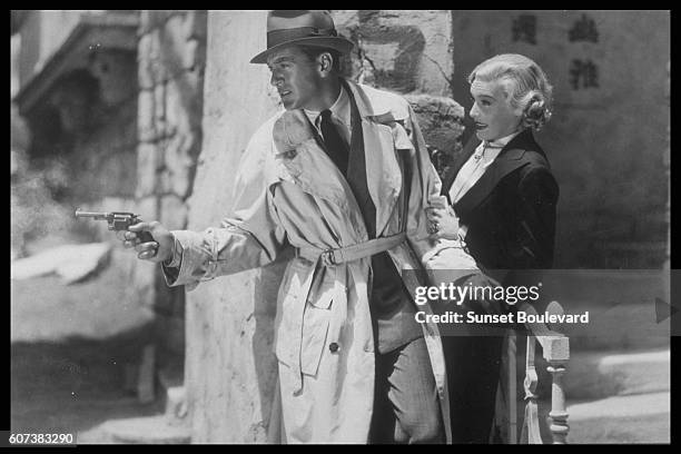 American actors Gary Cooper and Madeleine Carroll on the set of The General Died at Dawn, directed by Lewis Milestone.