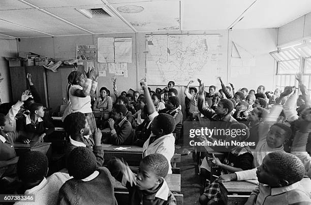 Using Afrikaans as the language of instruction, a black teacher gives a history lesson on the arrival of the first Dutch settlers in South Africa. |...