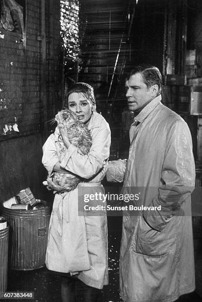 British actress Audrey Hepburn and American George Peppard on the set of Breakfast at Tiffany's, based on the novel by Truman Capote and directed by...