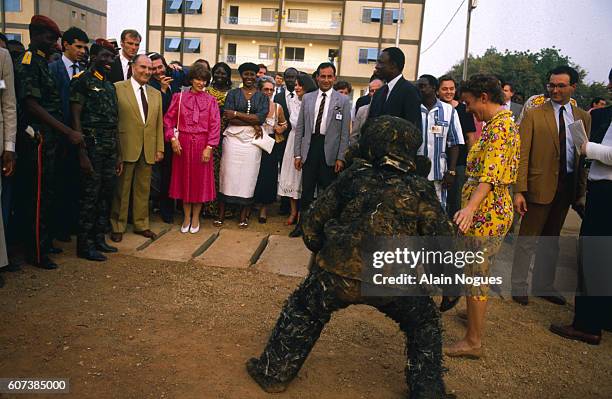 During his official visit to Burkina Faso, French President Francois Mitterrand and his wife, Danielle visit a local market with Burkina Faso...