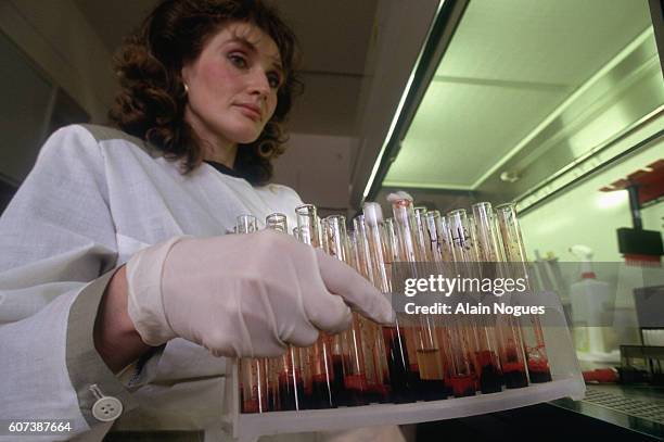 Woman carries test tubes in a serological diagnostic laboratory in Moscow. During the political and economic instability of the late 1980s and early...