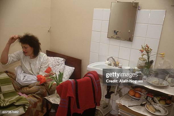 Patient suffering from AIDS sits in her bed in a Moscow hospital. During the political and economic instability of the late 1980s and early 1990s,...