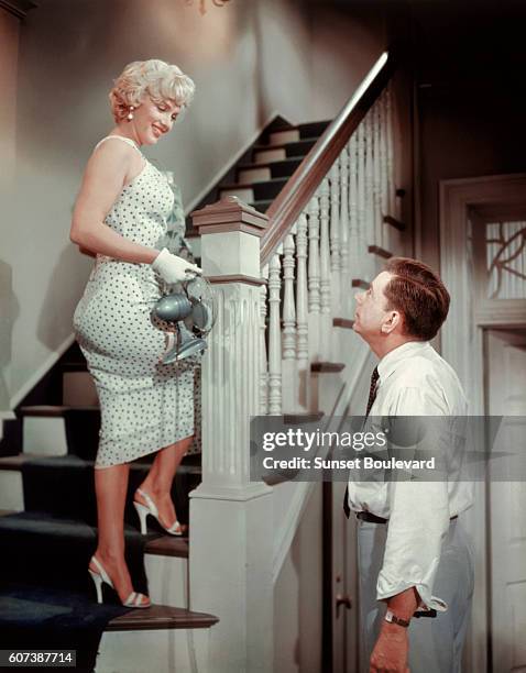 American actors Marilyn Monroe and Tom Ewell on the set of The Seven Year Itch, directed by Billy Wilder.