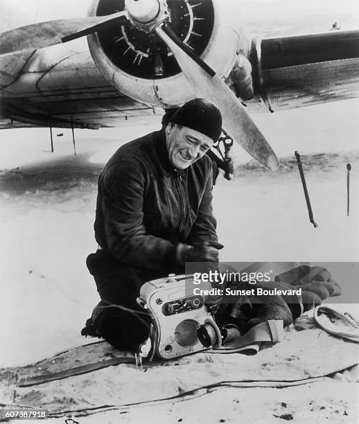 American actor John Wayne on the movie set of "Island in the Sky" , directed by William Wellman.