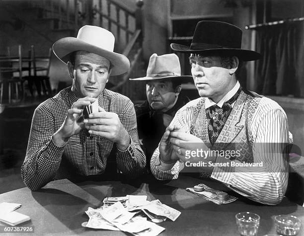 Actors John Wayne and Ward Bond on the movie set of "Tall in the Saddle" , directed by Edwin L. Marin.