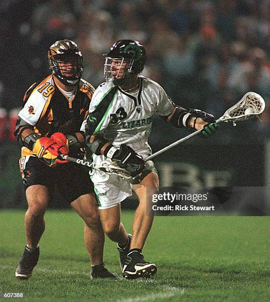 Kevin Finneran of the Long Island Lizards carries the ball while Cory Kahoun of the Rochester Rattlers defends in their Major League Lacrosse game at...