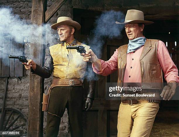 Actors John Wayne and Kirk Douglas on the set of The War Wagon, based on the novel by Clair Huffaker and directed by Burt Kennedy.