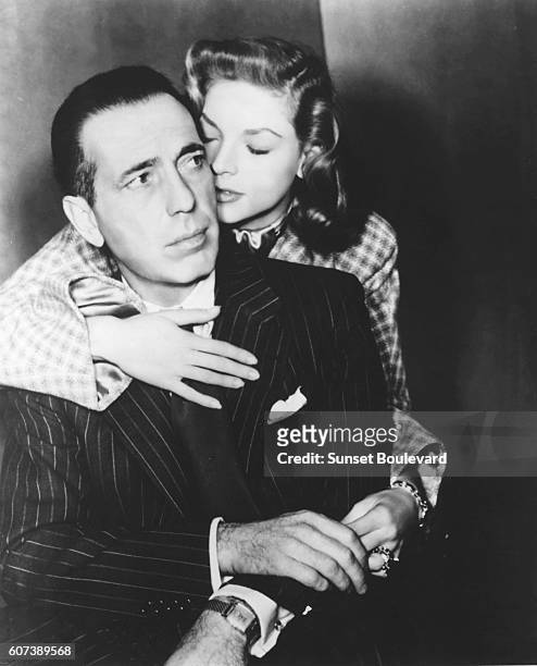 American actress Lauren Bacall and actor Humphrey Bogart on the set of Dark Passage, based on the novel by David Goodis and directed by Delmer Daves.