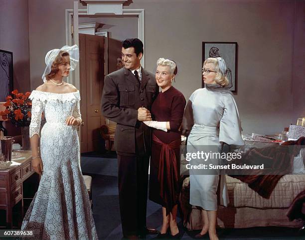 American actors Rory Calhoun, Lauren Bacall, Betty Grable and Marilyn Monroe on the set of How to Marry a Millionaire, directed by Jean Negulesco.