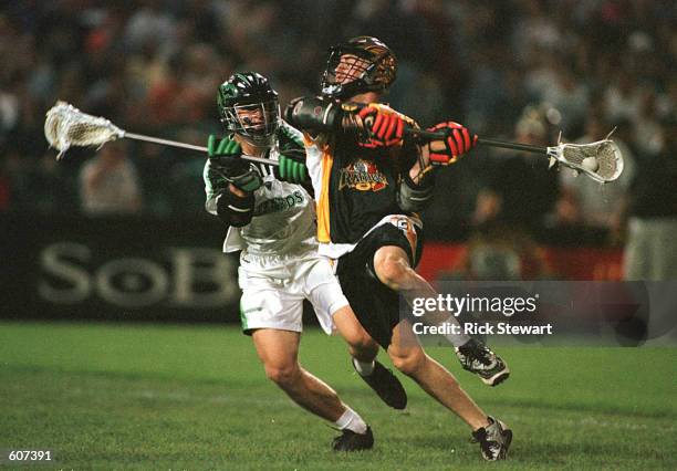 Mike Regan of the Rochester Rattlers winds up to shoot as A.J. Hougen of the Long Island Lizards defends in their Major League Lacrosse game at...