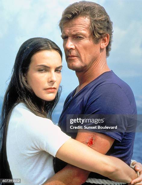 French actress Carole Bouquet and British actor Roger Moore on the set of For Your Eyes Only, directed by John Glen.