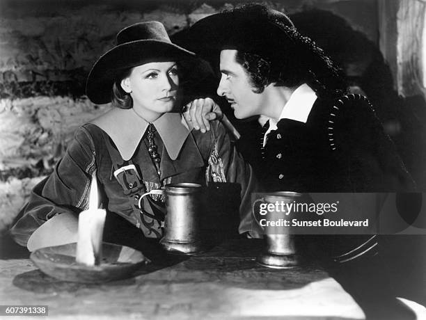 Actress Greta Garbo and actor John Gilbert on the set of "Queen Christina".