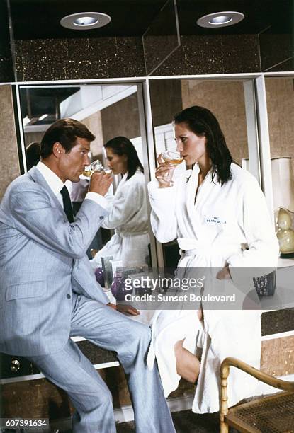 Actor Roger Moore and actress Maud Adams on the set of "The Man With The Golden Gun".