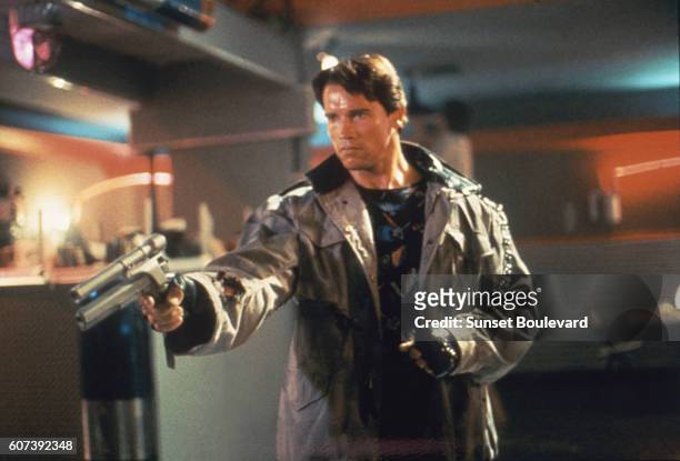 Actor Arnold Schwarzenegger as Terminator points his gun in a diner during a scene in 'The Terminator', 1984.