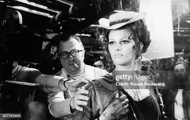 Italian actress Claudia Cardinale with director, screenwriter and producer Sergio Leone on the set of his movie C'era una volta il West .