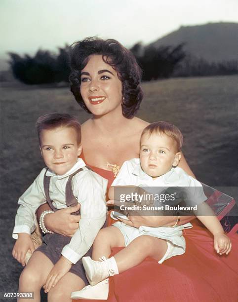 British-American actress Elizabeth Taylor with her two sons Michael Howard and Christopher that she had when she was married to Michael Wilding.