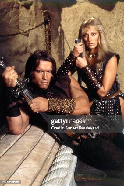 Austrian-born American actor Arnold Schwarzenegger and American actress Sandahl Bergman on the set of Conan the Barbarian, directed by John Milius.