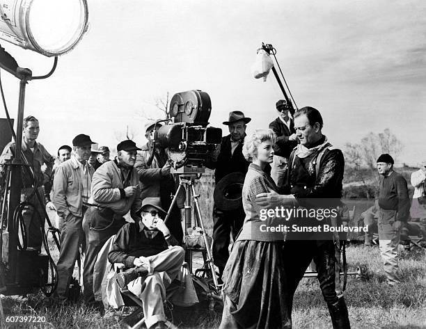 American actors Constance Towers and John Wayne with director John Ford on the set of his movie The Horse Soldiers.